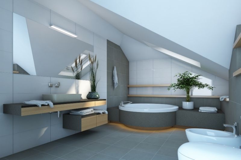 Attic bathroom with a sloped ceiling, round soaking tub and floating timber vanity