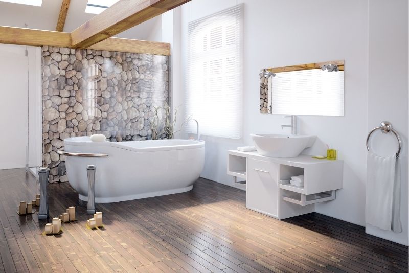 Bathroom with a freestanding tub, stone feature wall and floating vanity